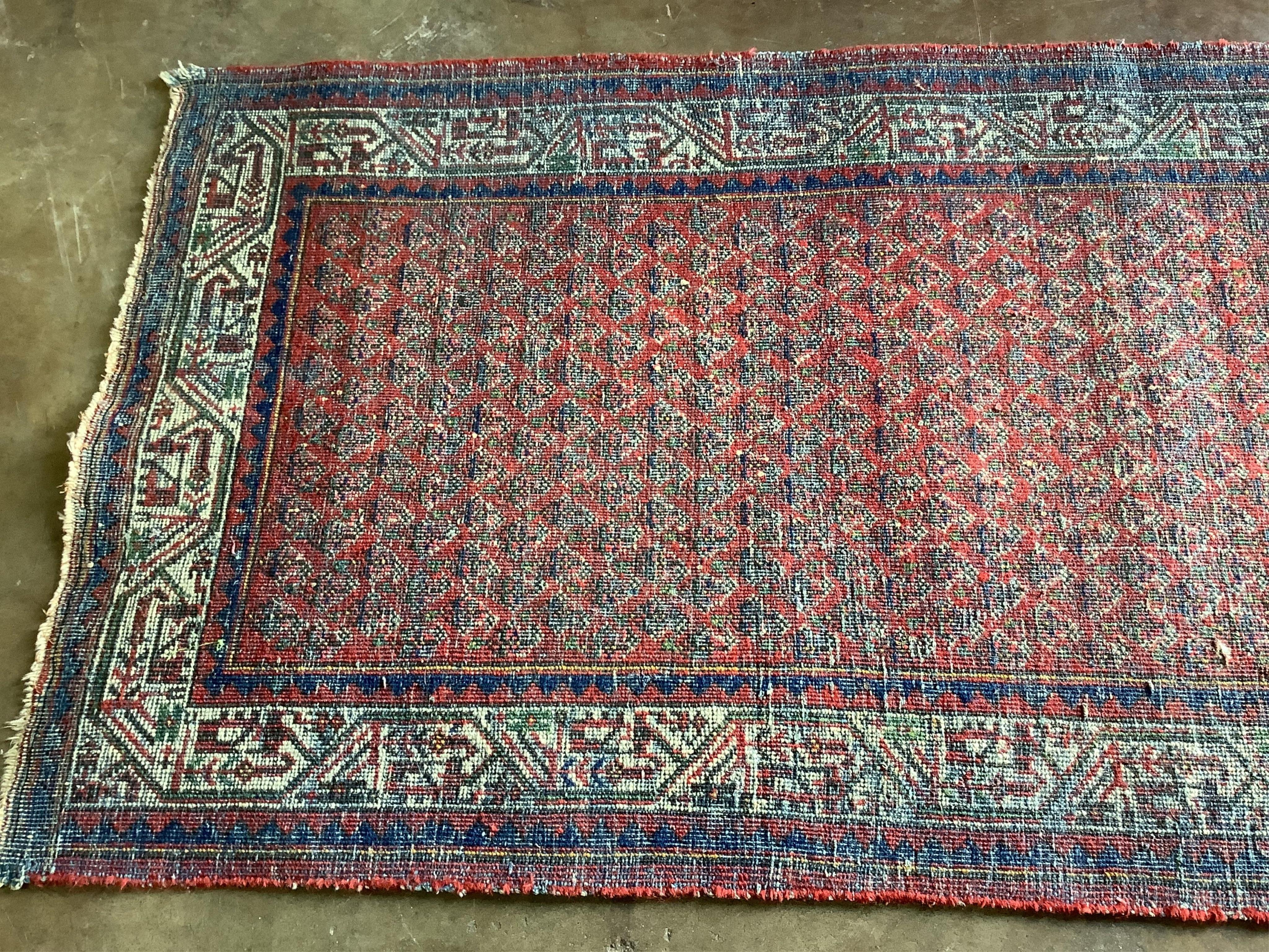 A pair of North West Persian brick red ground rugs, each 124 x 79cm. Condition - fair